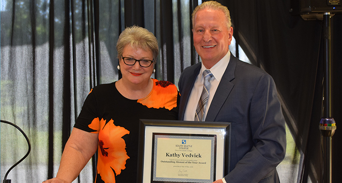 Kathy Vedvick receives the 2016 Outstanding Alumni Award from South Seattle College President Gary Oertli 
