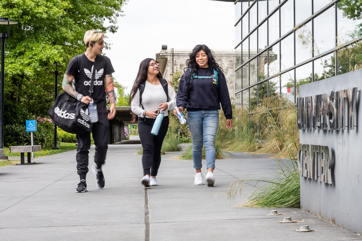 Three students walking near University Center 