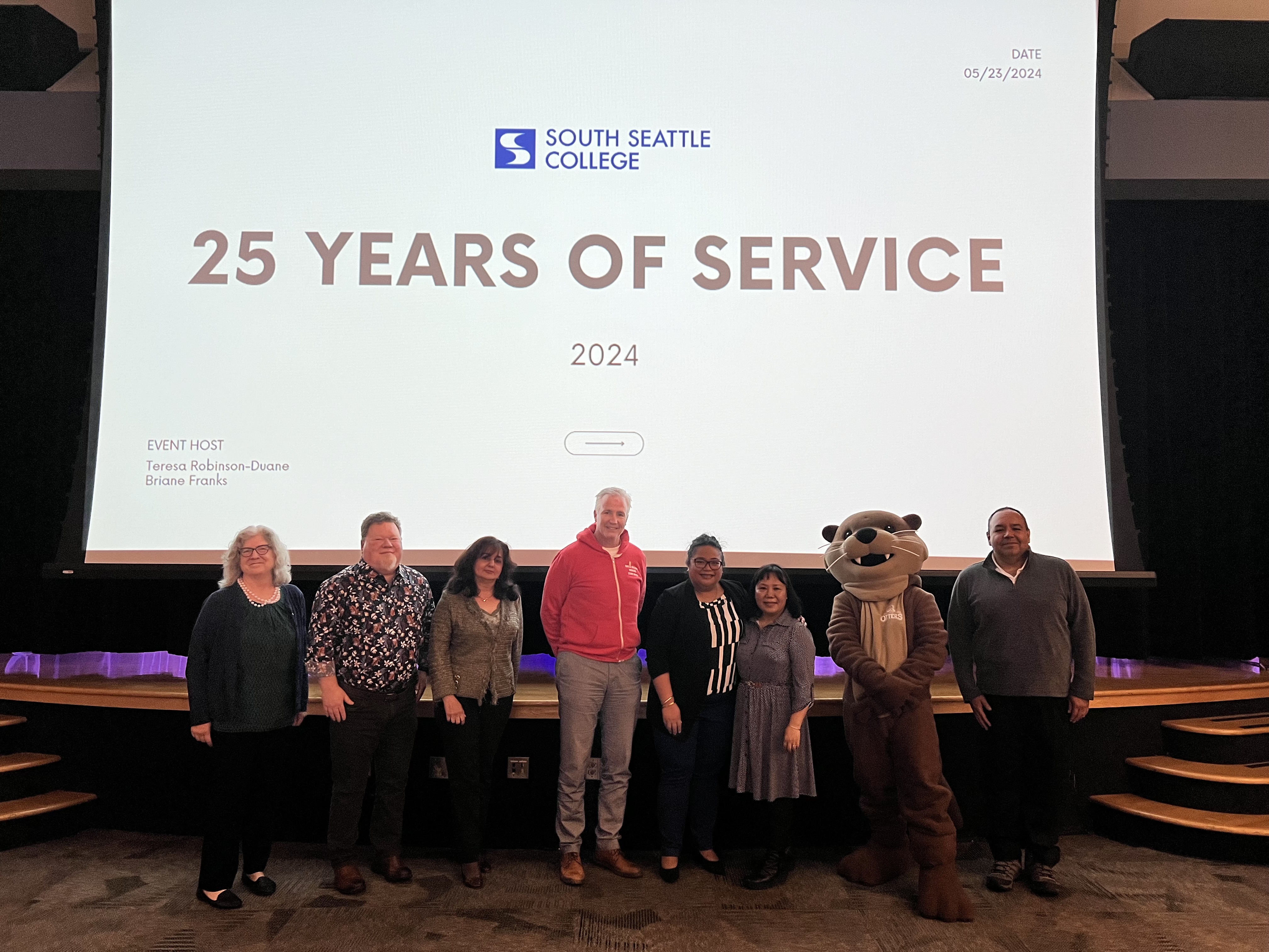 South employees who have been with the college for 25 years stand together for a photo with Seattle Colleges Chancellor Rosie Rimando-Chareunsap and an Otter mascot.