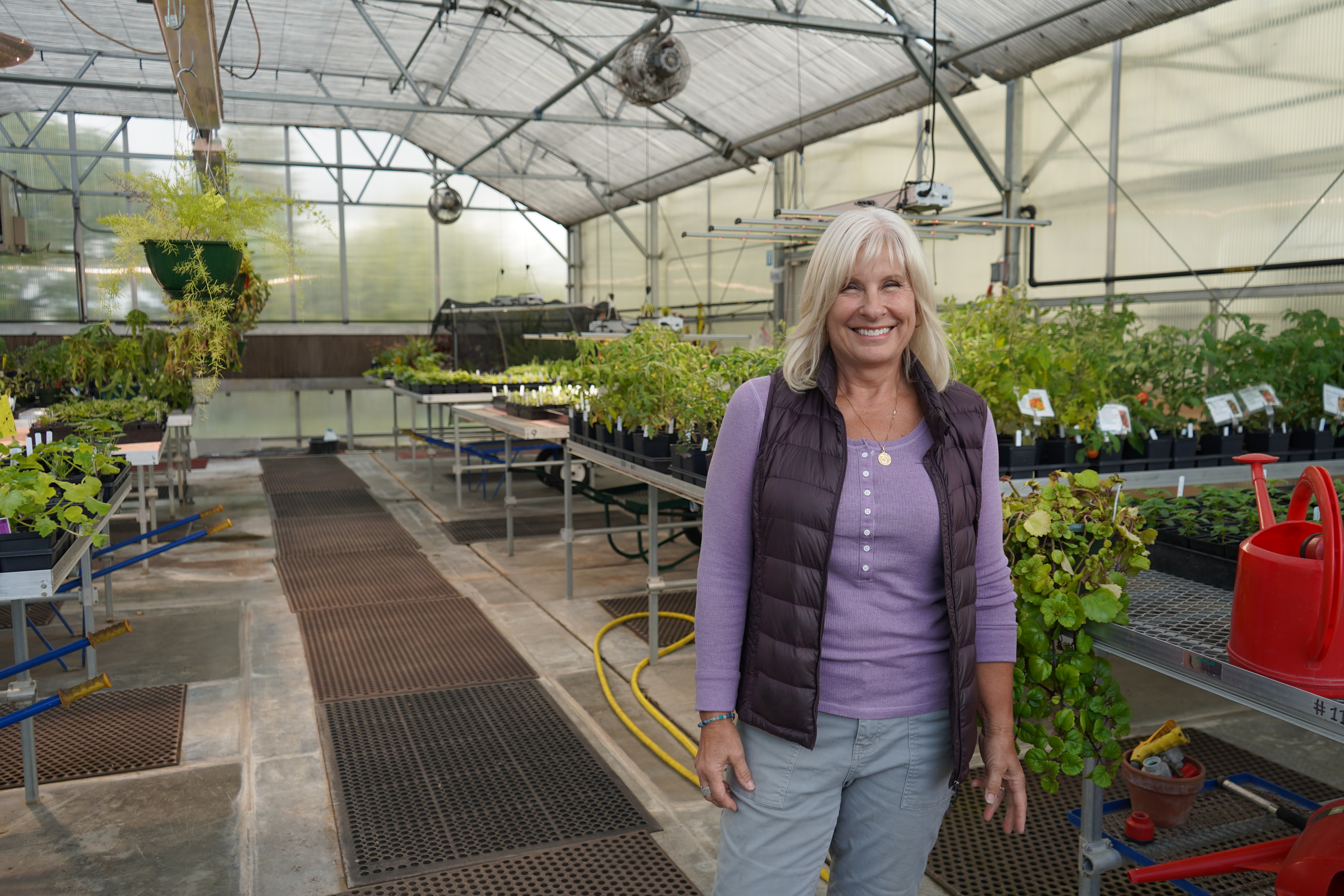 Landscape Horticulture student Shelley Hurst poses in South's greenhouse